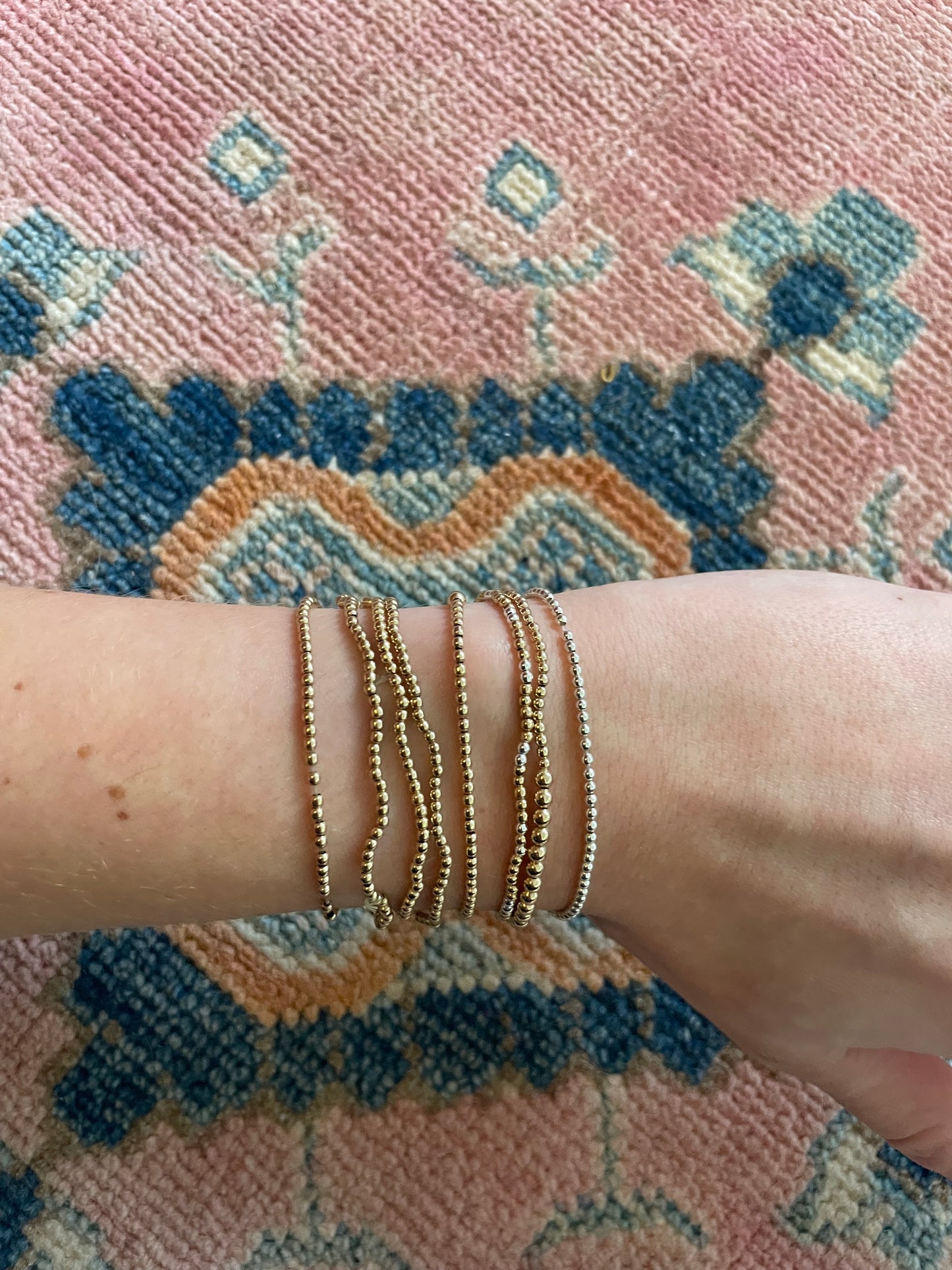 Gold beaded bracelet with heart charm