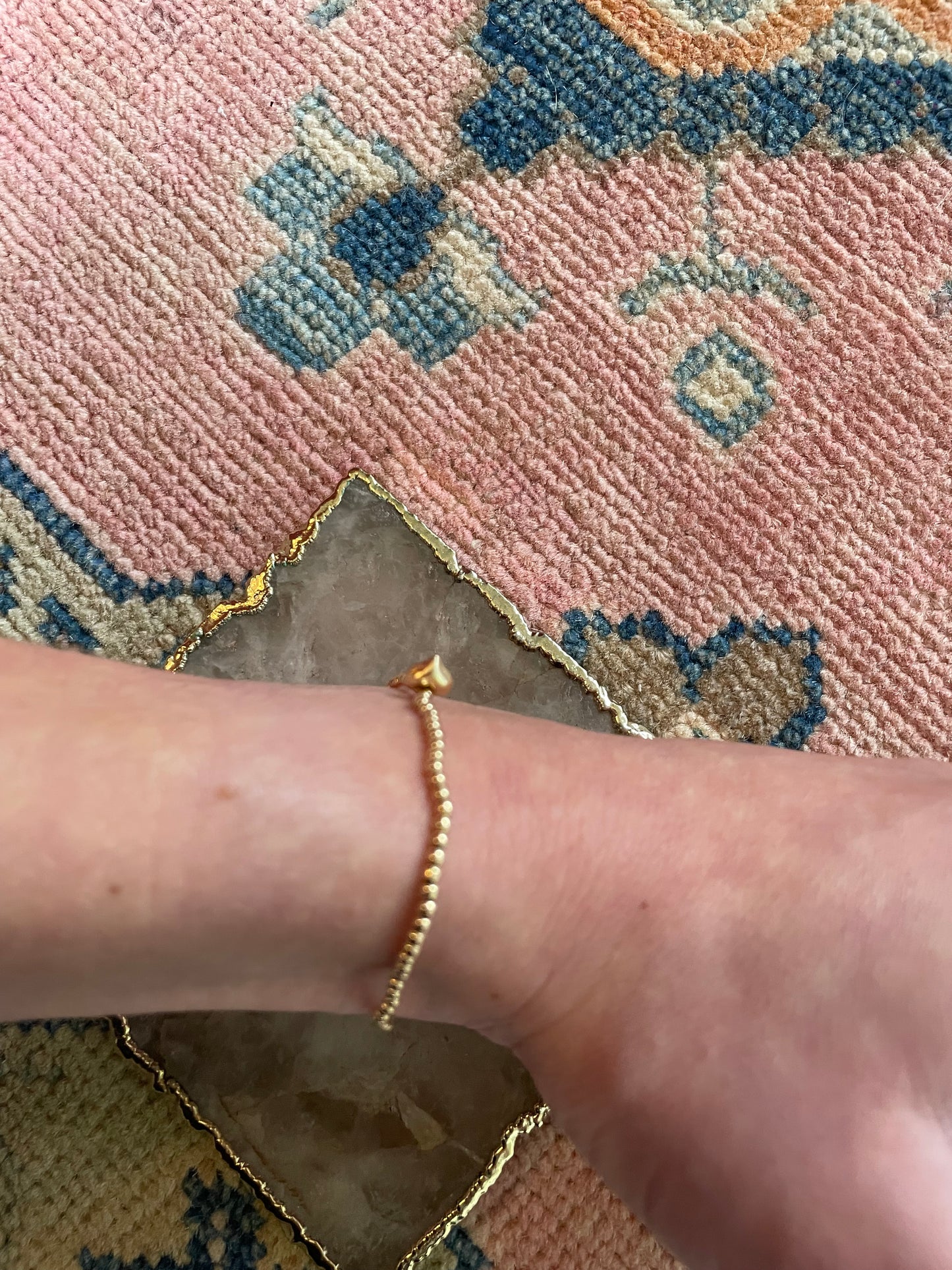 Gold beaded bracelet with heart charm